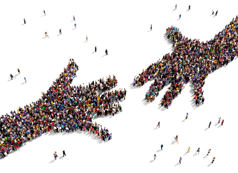 People standing in the shapes of two hands reaching out to connect