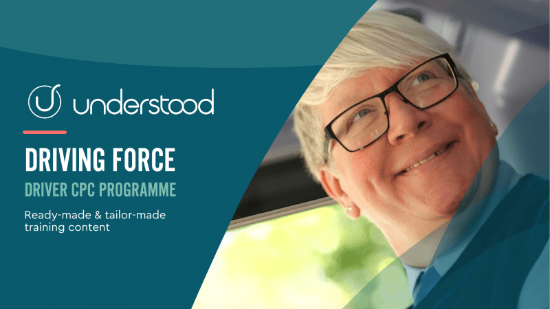 Bus driving smiling and looking to the right from the cab of the bus