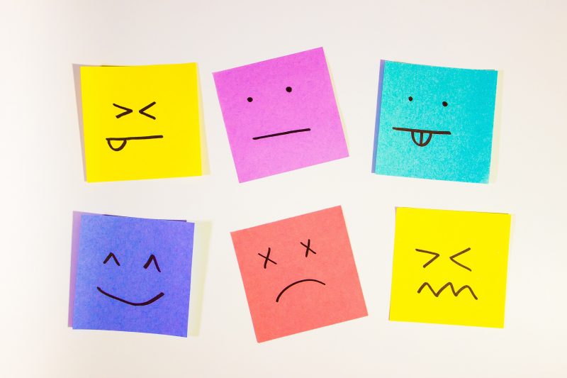 Colourful post it notes with different expressions which represent emotions