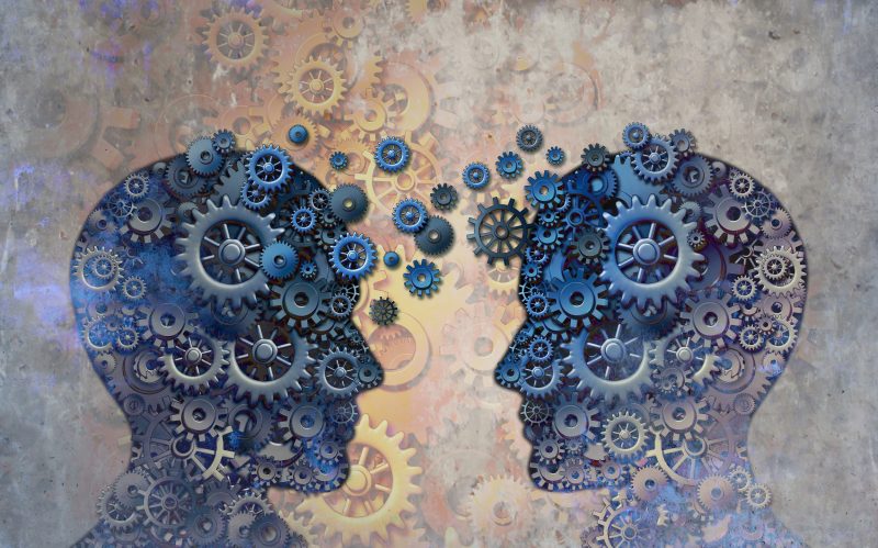 graphic of two heads in silhouette with cogs shared between them