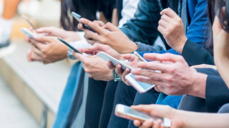 People holding and using mobile phones with just their hands visible