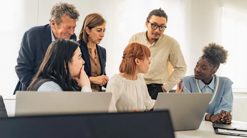 Inclusive leader listening as a team member contributes during a meeting