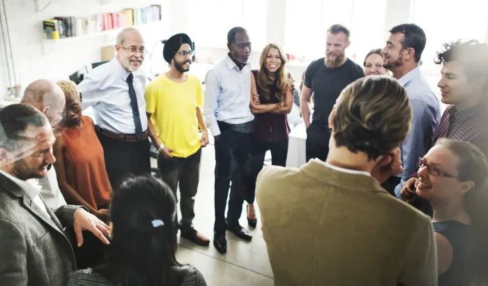 Diverse group of employees talking during a workplace sexual harassment training session